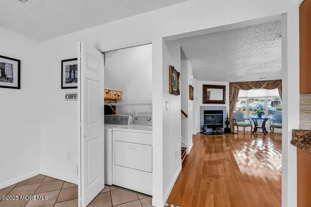 a living room with furniture a rug and white walls