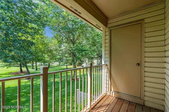 a view of a balcony with wooden floor
