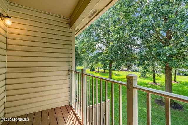 a view of a chair and table in backyard of the house