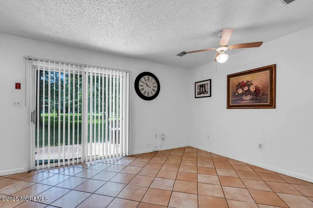 a view of an empty room with a fan