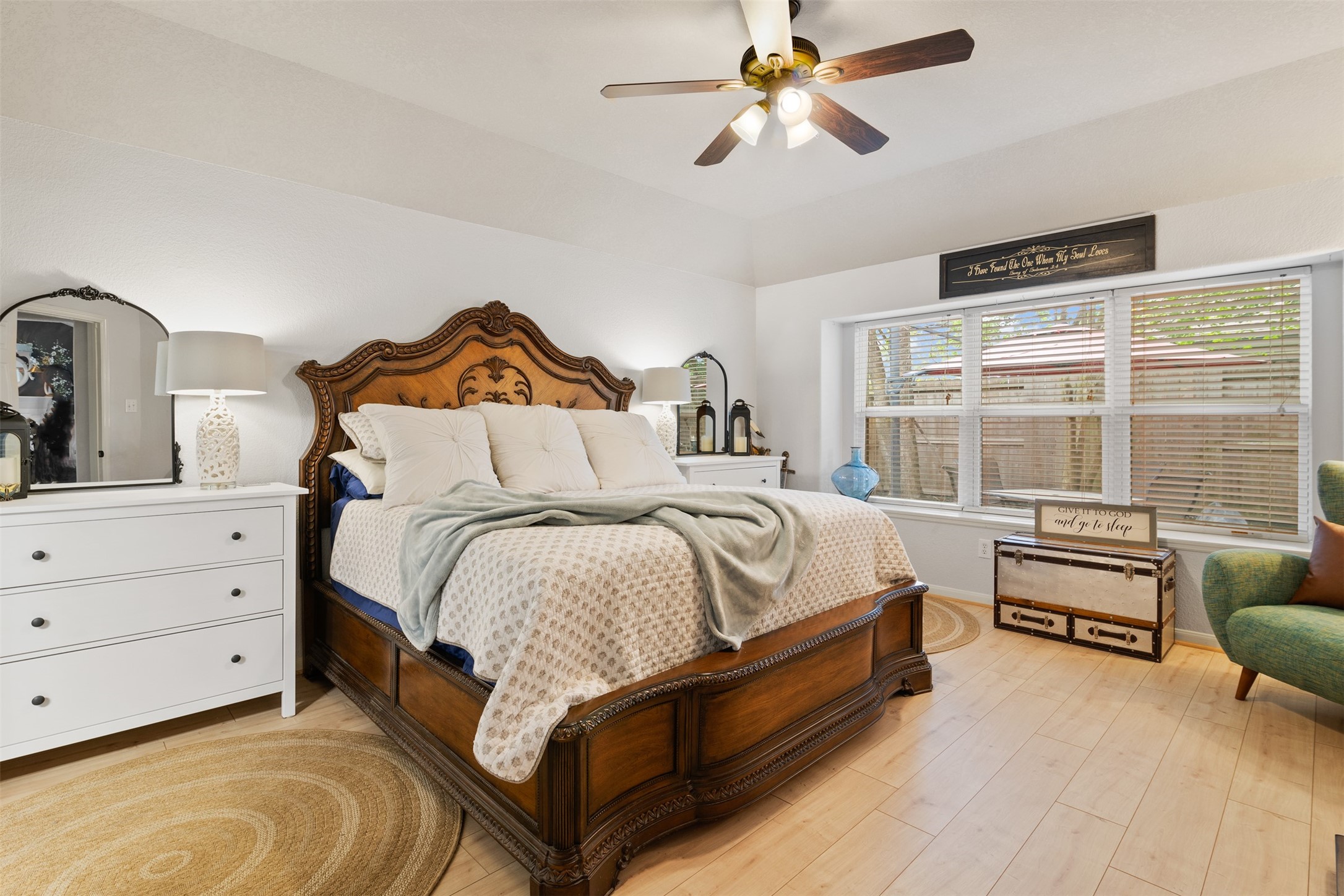 19306 Young Oak Street Spring, TX 77379 - Photo 14 of 28 Spacious primary bedroom features laminate floors installed in 2023, large bay windows over looking the backyard and ceiling fan.