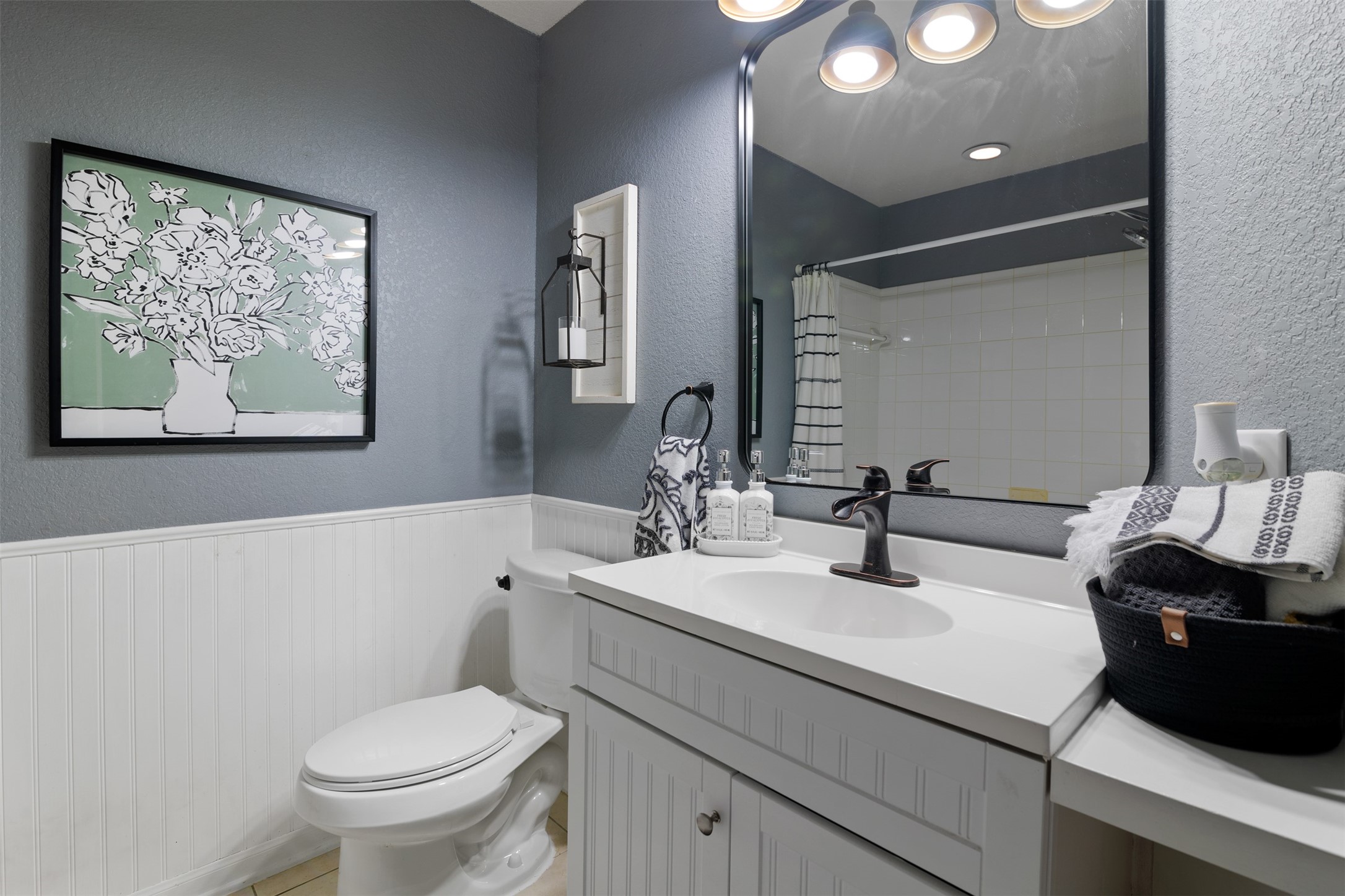 19306 Young Oak Street Spring, TX 77379 - Photo 20 of 28 Secondary full bathroom features single sink vanity with decorative wainscotting and tub/shower combo.