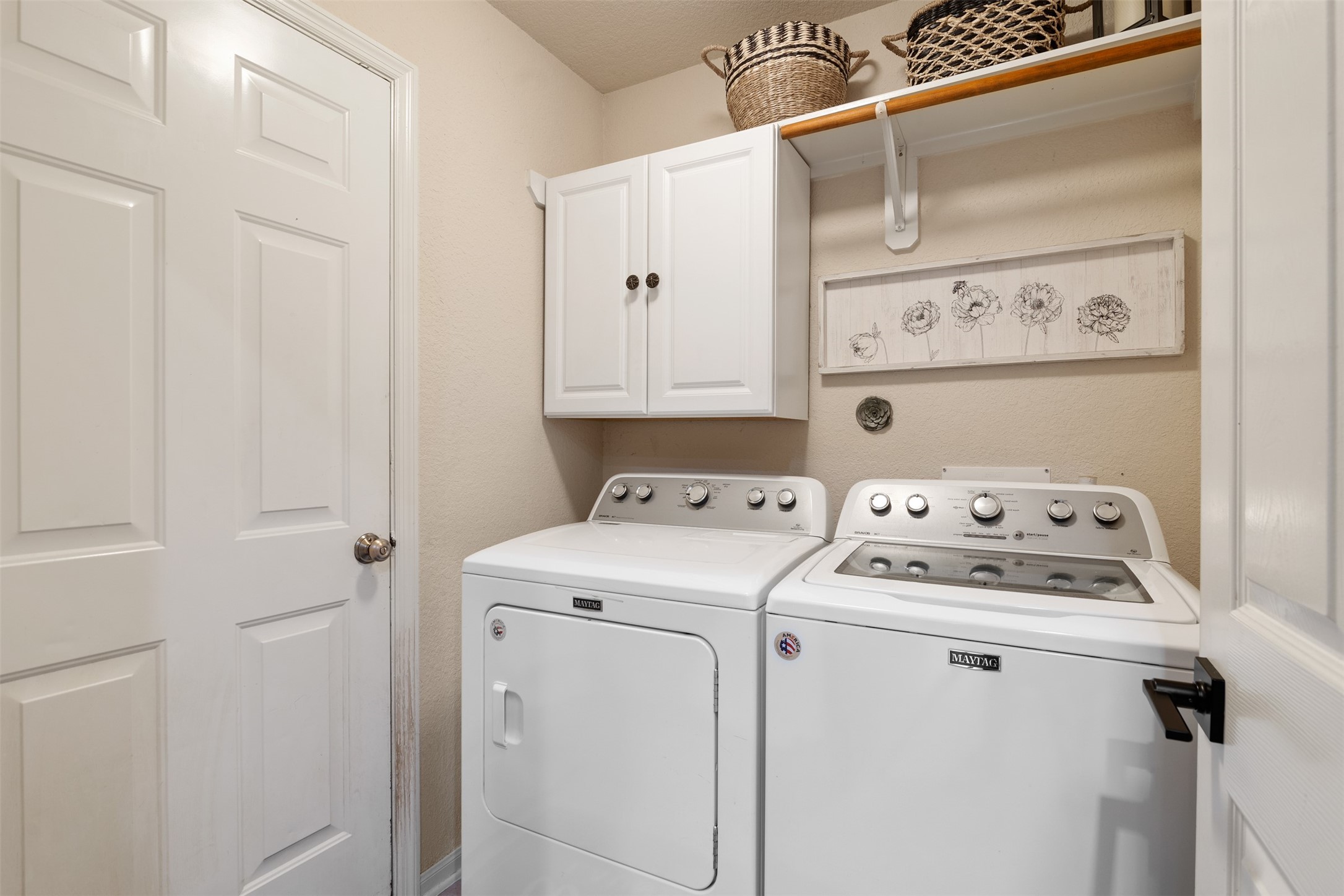 19306 Young Oak Street Spring, TX 77379 - Photo 21 of 28 Utility room has an above cabinet for storage and rod for hanging space.