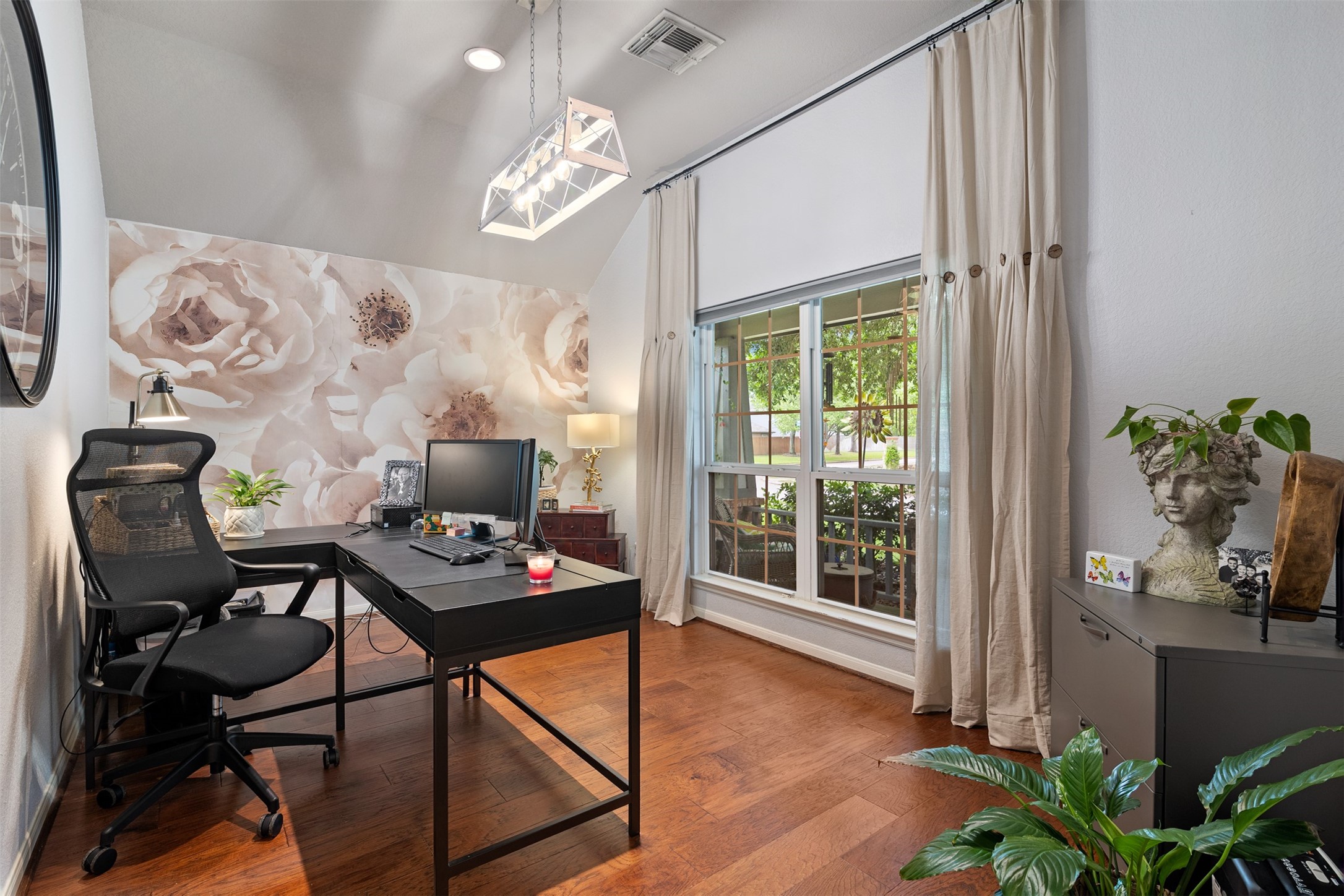 19306 Young Oak Street Spring, TX 77379 - Photo 4 of 28 The office has been updated to include laminate flooring installed in 2023 and custom light fixture along with a stunning mural accent wall and large windows for great views to front porch and yard.