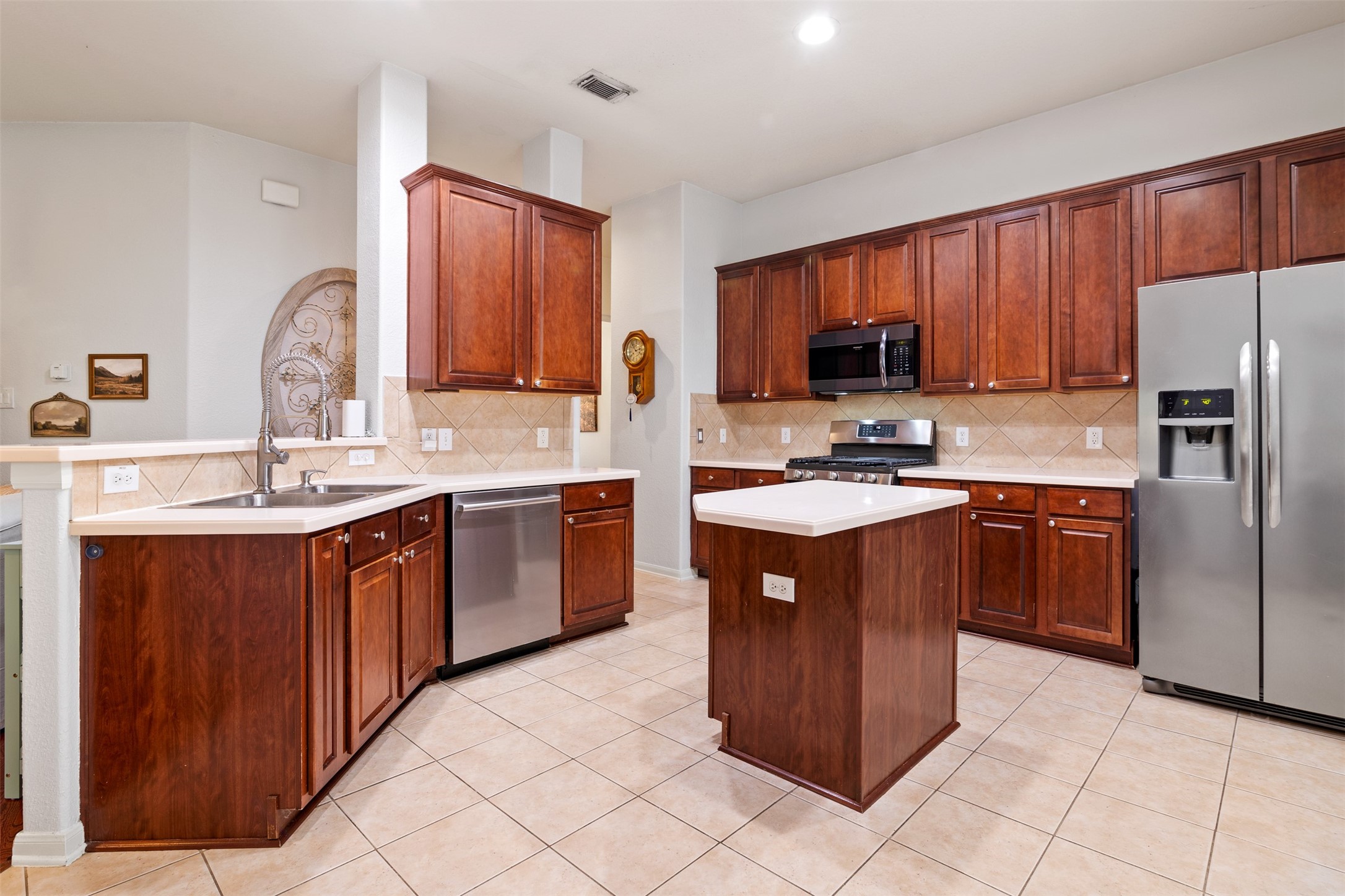 19306 Young Oak Street Spring, TX 77379 - Photo 10 of 28 The kitchen is spacious with an abundance of storage with upper and lower cabinets and island and solid surface countertops.