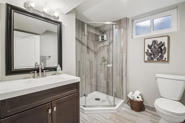 a bathroom with a sink toilet a mirror and shower