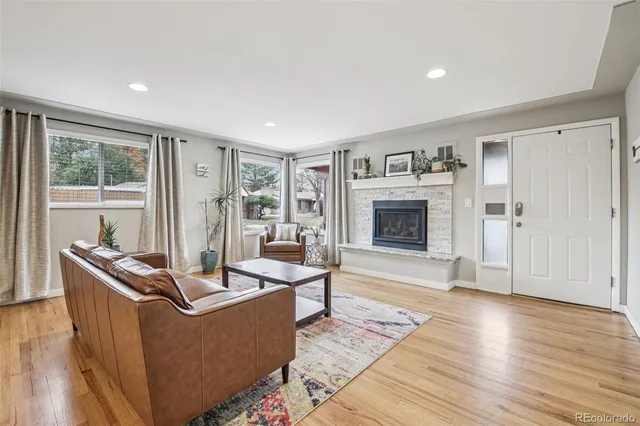a living room with furniture and a fireplace