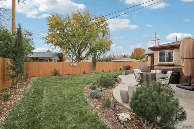 a view of a house with backyard and sitting area