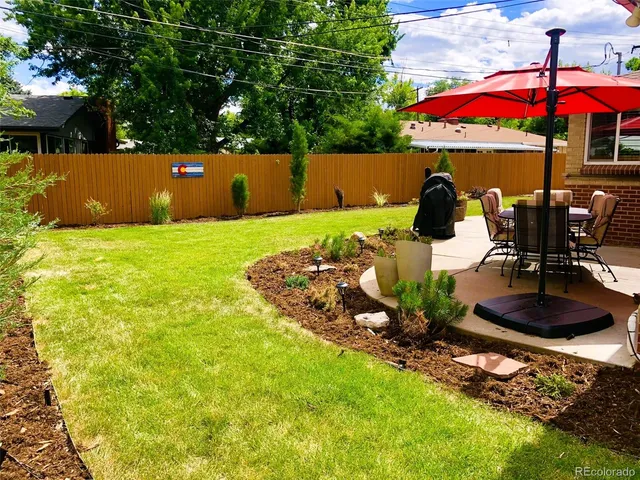 a view of a patio with table and chairs potted plants
