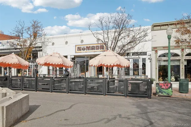 a view of a building with retail shops