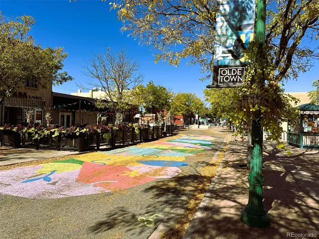 a view of swimming pool with outdoor seating and trees in the background