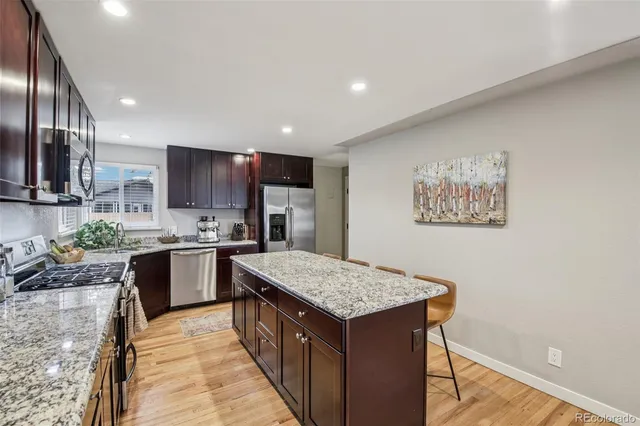 a kitchen with a sink refrigerator and microwave