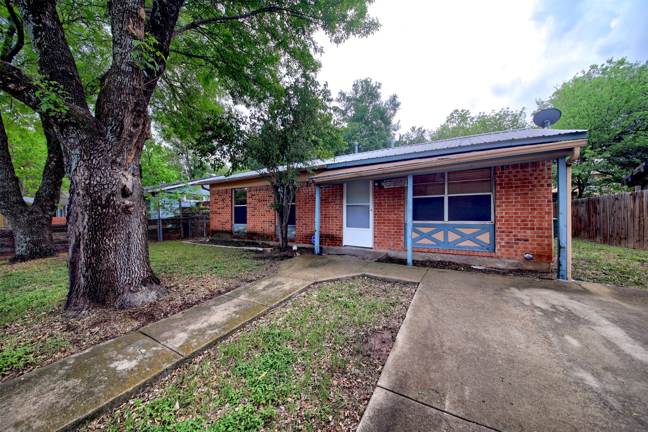 6115 Carnation Terrace Austin, TX 78741 - Photo 2 of 4 a front view of a house with a garden and trees