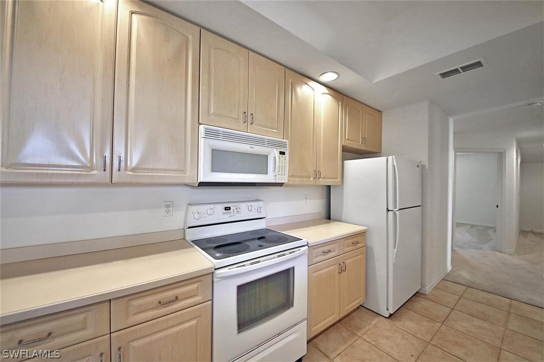 5220 Park Road, Unit 1 Fort Myers, FL 33908 - Photo 15 of 29 a kitchen with stainless steel appliances white cabinets and a refrigerator