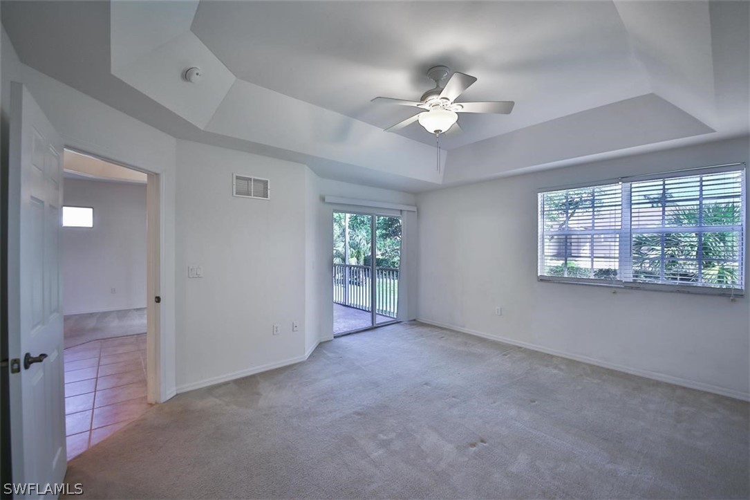 5220 Park Road, Unit 1 Fort Myers, FL 33908 - Photo 16 of 29 an empty room with windows and chandelier fan