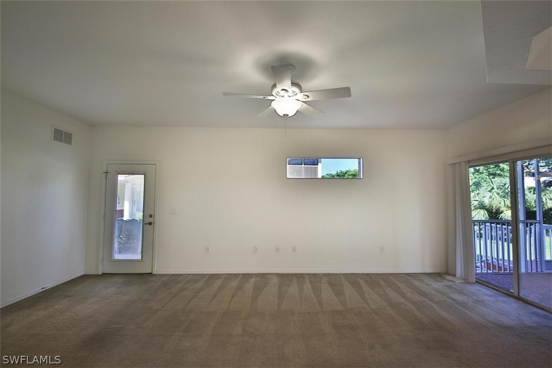 5220 Park Road, Unit 1 Fort Myers, FL 33908 - Photo 4 of 29 an empty room with windows and ceiling fan