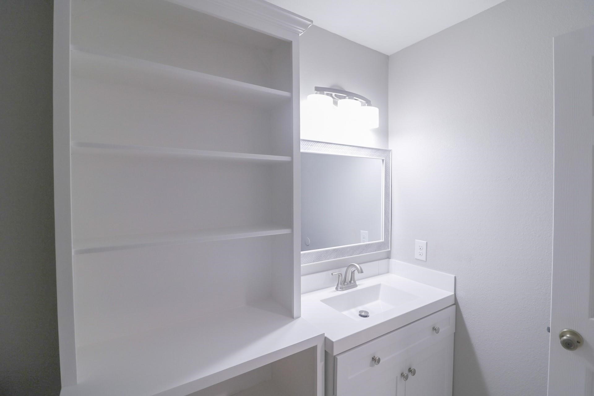 6150 Ridgeway Drive Houston, TX 77033 - Photo 17 of 36 a bathroom with a sink and a mirror