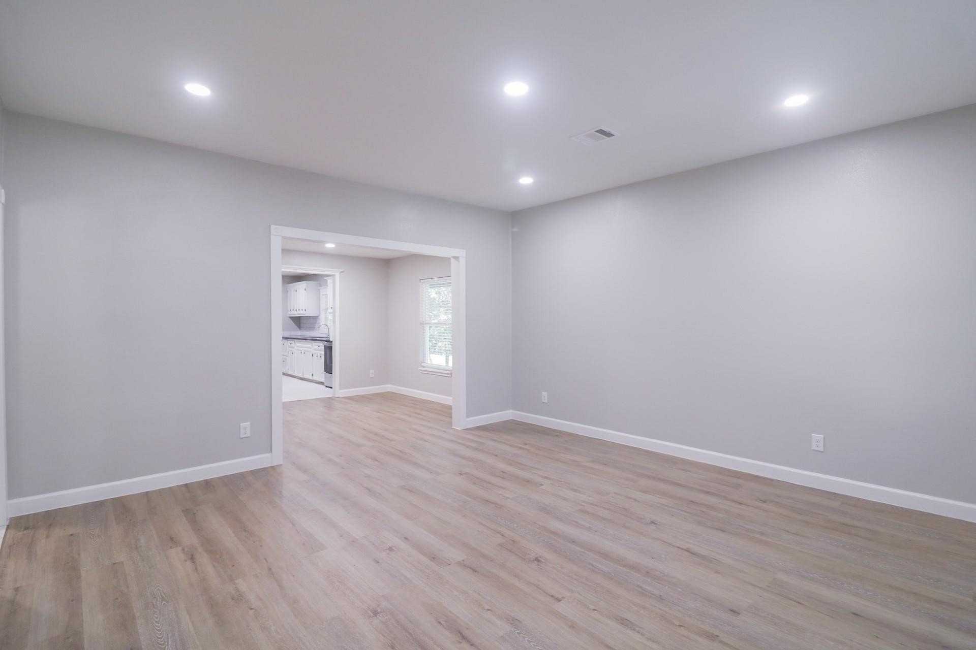 6150 Ridgeway Drive Houston, TX 77033 - Photo 23 of 36 a view of an empty room with wooden floor and closet