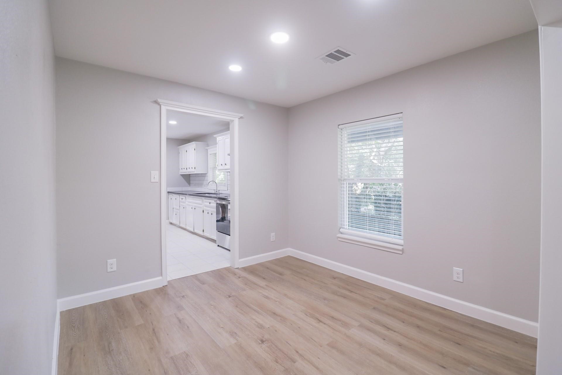 6150 Ridgeway Drive Houston, TX 77033 - Photo 25 of 36 an empty room with wooden floor and windows
