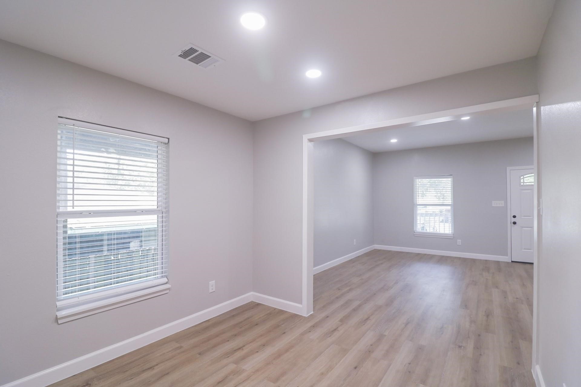 6150 Ridgeway Drive Houston, TX 77033 - Photo 26 of 36 a view of an empty room with wooden floor and a window