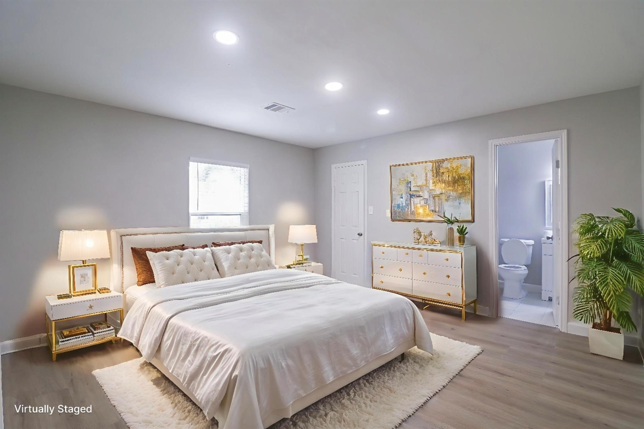 6150 Ridgeway Drive Houston, TX 77033 - Photo 5 of 36 a spacious bedroom with a bed and a potted plant