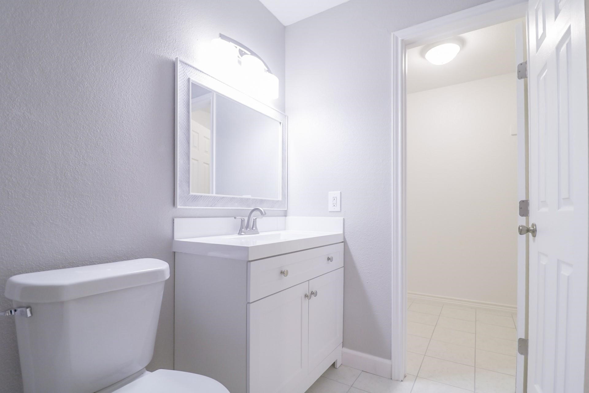 6150 Ridgeway Drive Houston, TX 77033 - Photo 8 of 36 a bathroom with a toilet sink and mirror