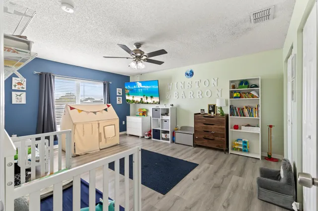 a view of a bedroom with furniture and toys