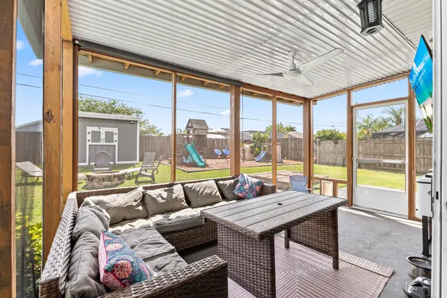 a living room with furniture and floor to ceiling windows