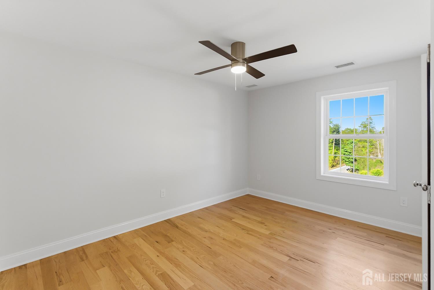 3 Lillian Street Fords, NJ 08863 - Photo 15 of 28 an empty room with window and ceiling fan