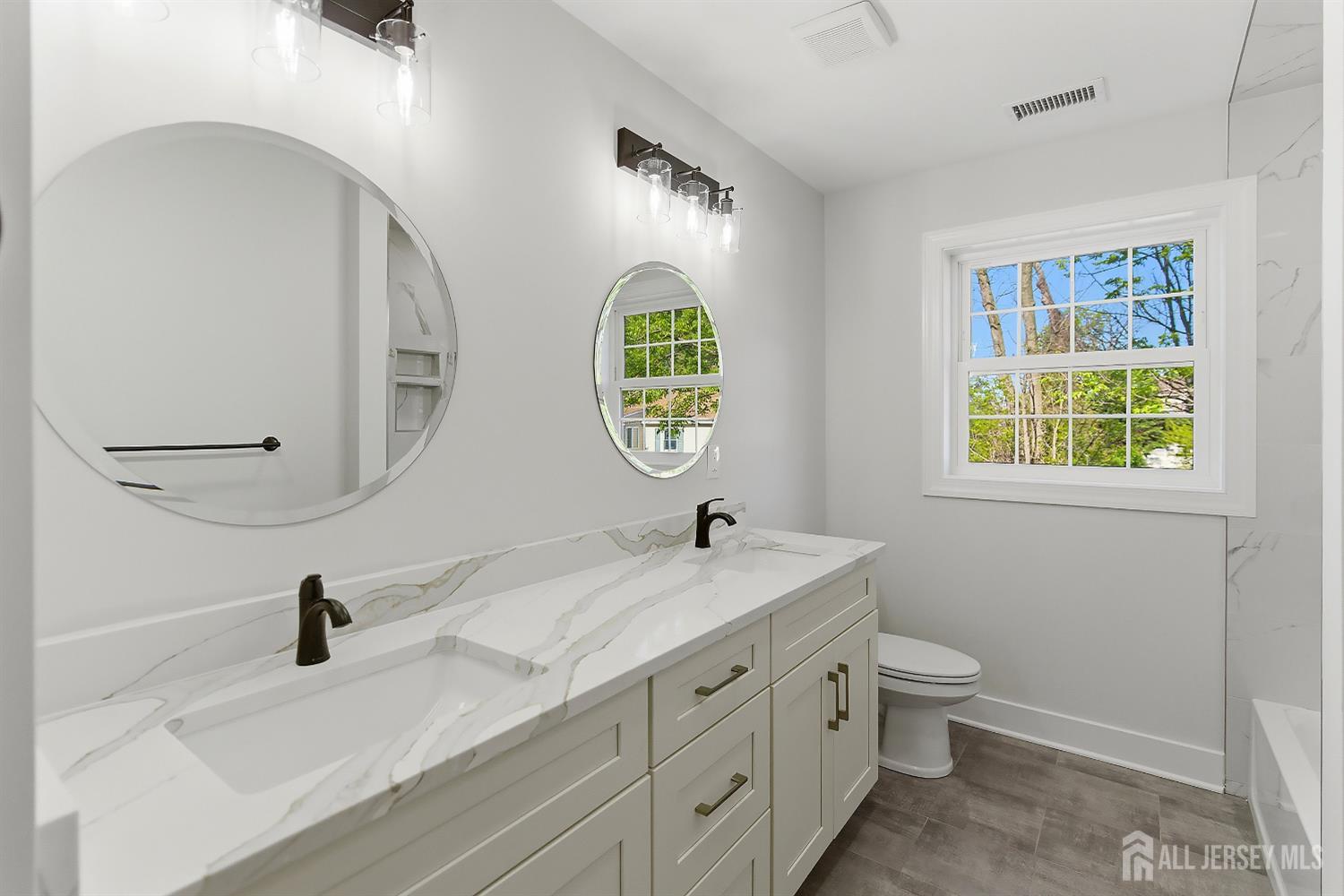 3 Lillian Street Fords, NJ 08863 - Photo 16 of 28 a bathroom with 2 sink and a mirror
