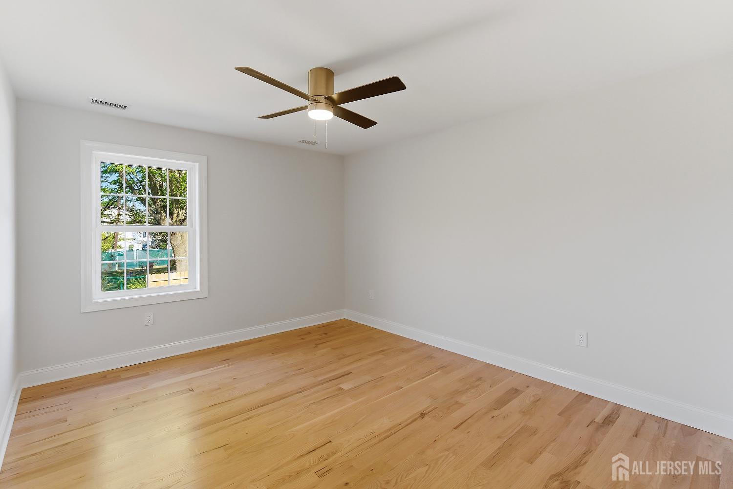 3 Lillian Street Fords, NJ 08863 - Photo 18 of 28 an empty room with a window and ceiling fan