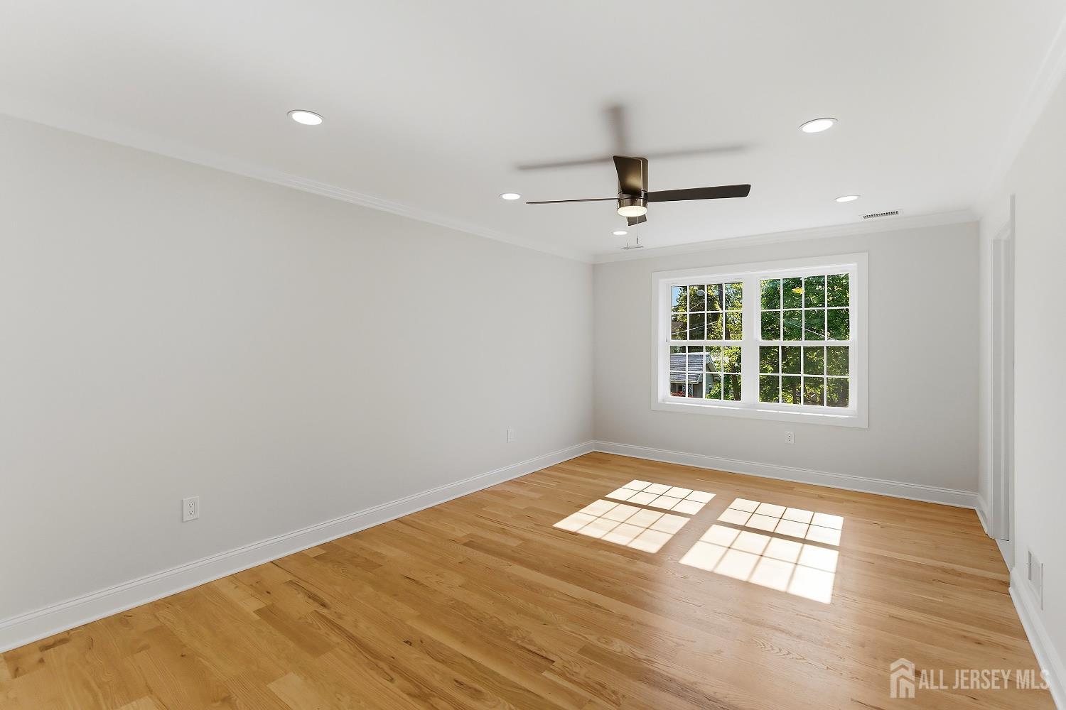 3 Lillian Street Fords, NJ 08863 - Photo 19 of 28 an empty room with windows and ceiling fan