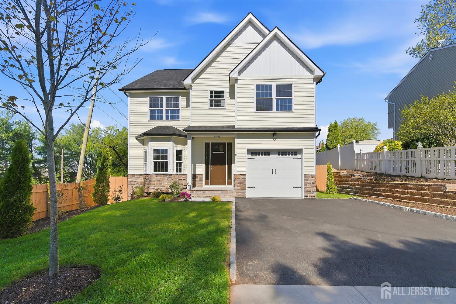 3 Lillian Street Fords, NJ 08863 - Photo 2 of 28 a front view of a house with a yard and garage