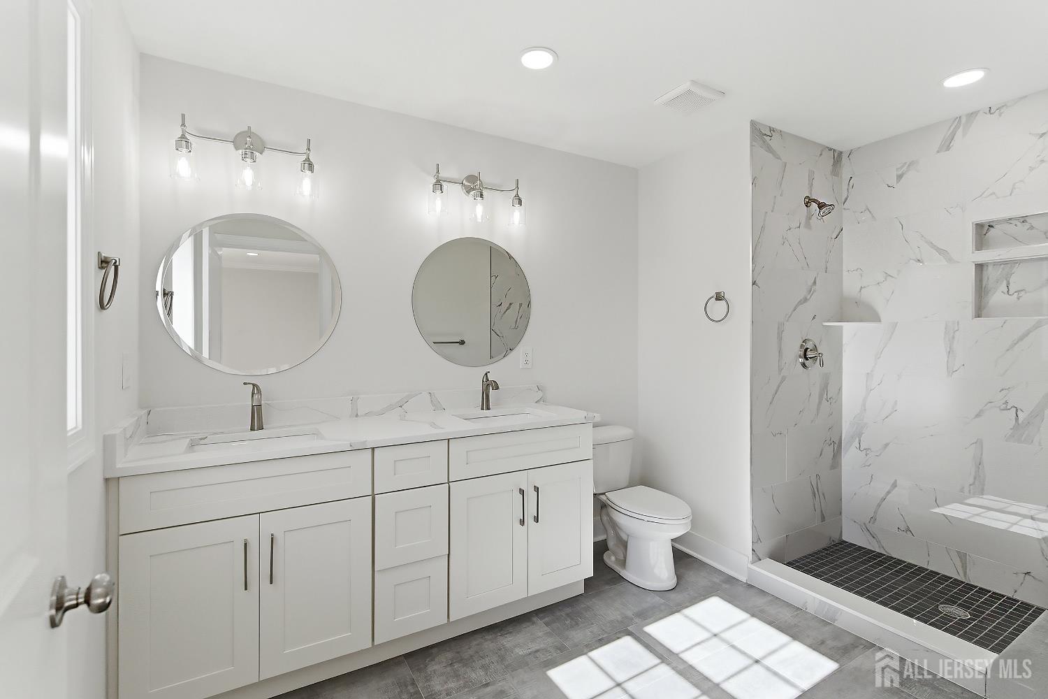 3 Lillian Street Fords, NJ 08863 - Photo 21 of 28 a bathroom with a double vanity sink toilet mirror and shower