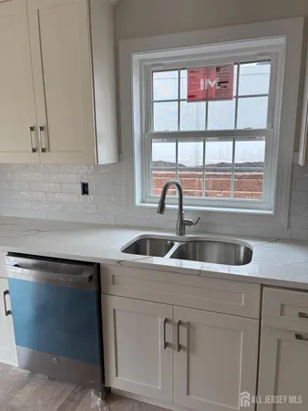 a kitchen with a sink and a window