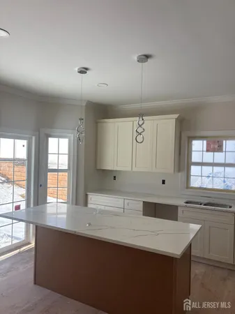 a kitchen with a sink window and cabinets