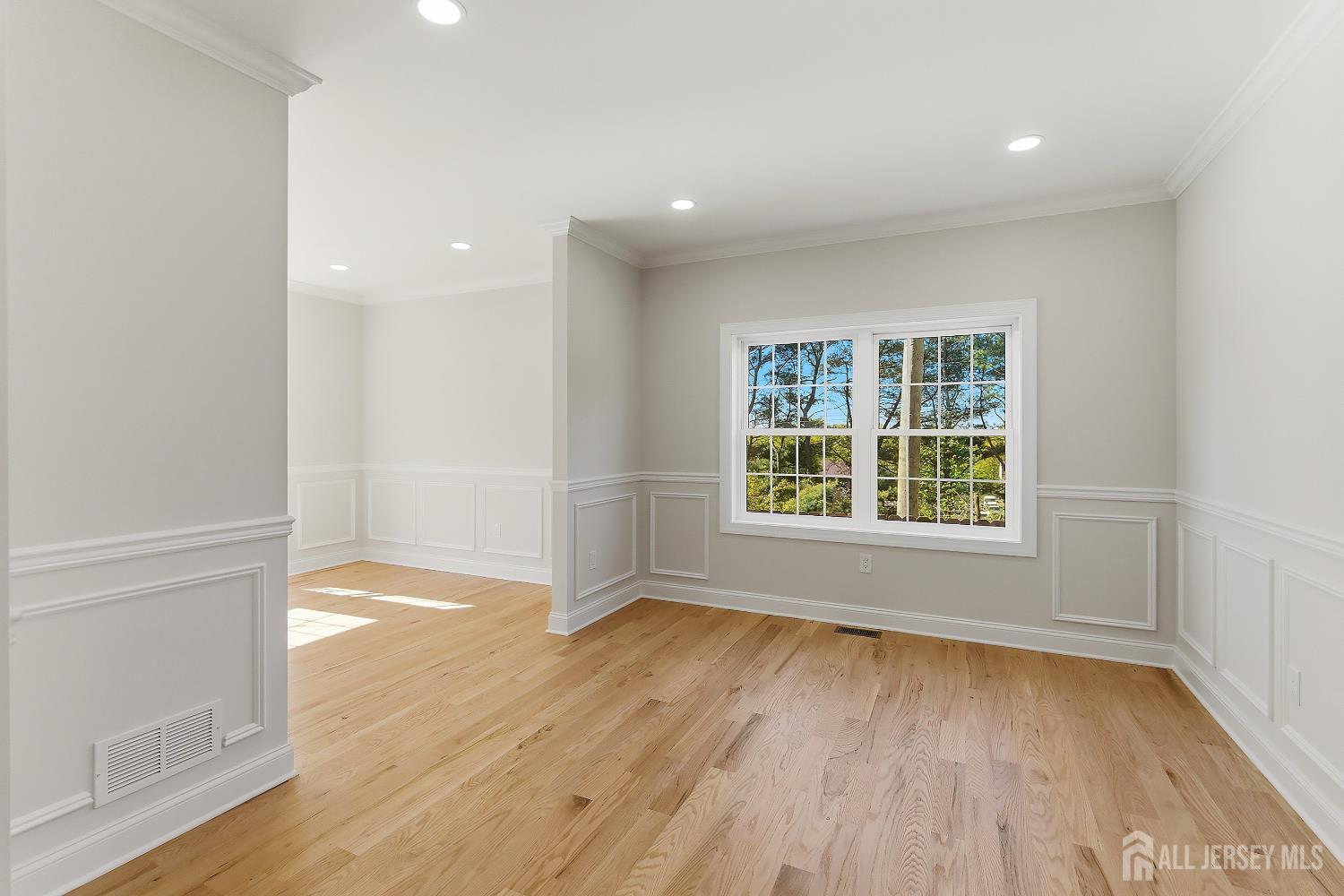 3 Lillian Street Fords, NJ 08863 - Photo 5 of 28 an empty room with wooden floor and windows