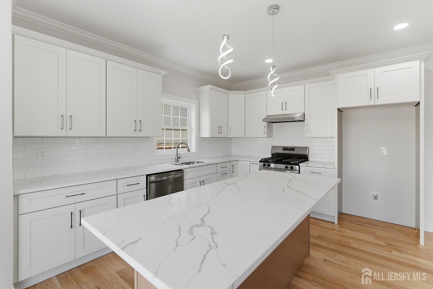 3 Lillian Street Fords, NJ 08863 - Photo 7 of 28 a kitchen with granite countertop white cabinets and white appliances