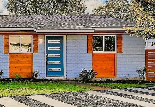 a front view of a house with a garden