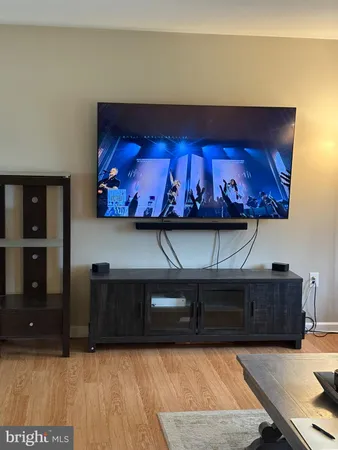 a living room with furniture and wall paintings