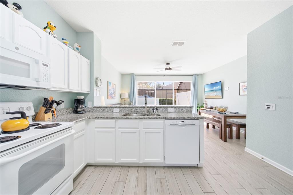 2556 Renshaw Street Kissimmee, FL 34747 - Photo 12 of 26 a kitchen with a sink stove and cabinets