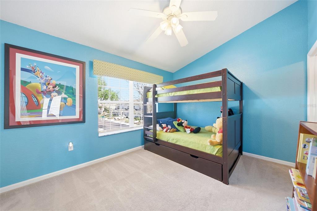 2556 Renshaw Street Kissimmee, FL 34747 - Photo 16 of 26 a bedroom with furniture and a window