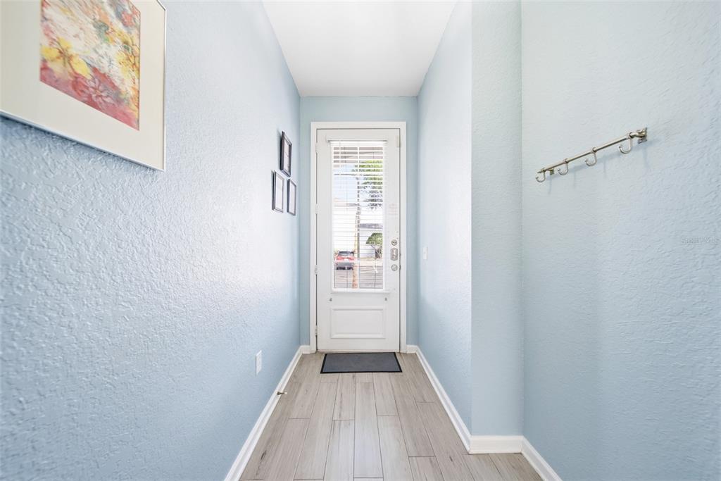 2556 Renshaw Street Kissimmee, FL 34747 - Photo 4 of 26 a view of a hallway with wooden floor and a bathroom