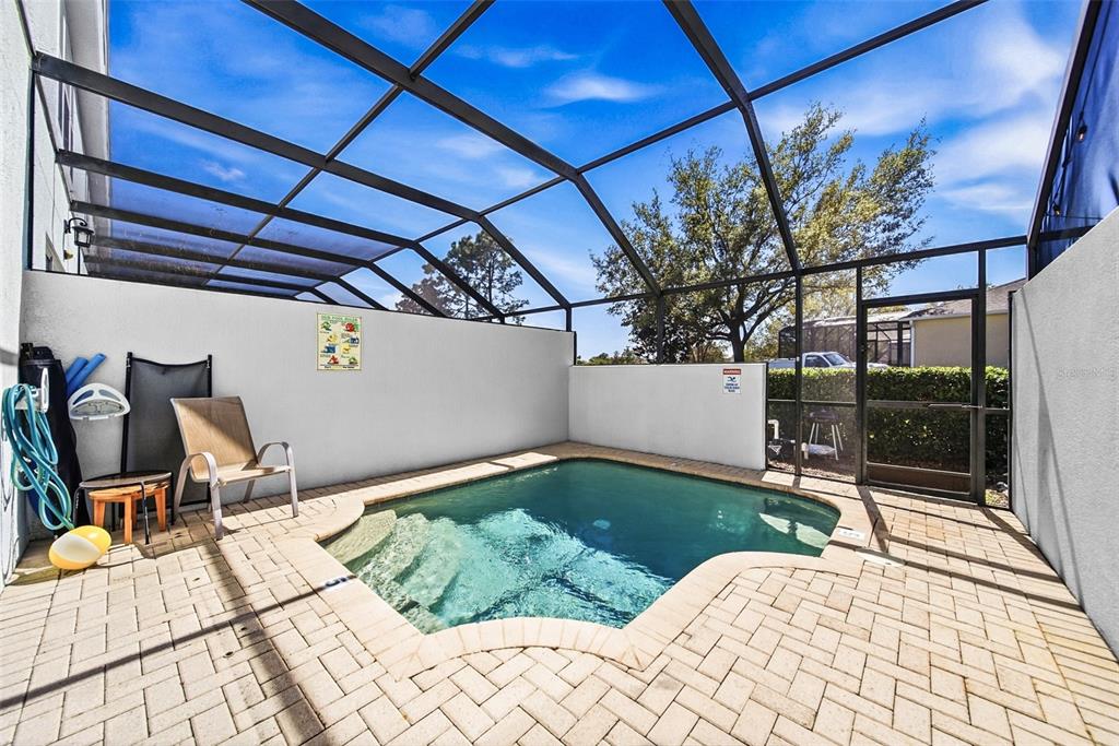 2556 Renshaw Street Kissimmee, FL 34747 - Photo 8 of 26 a view of a patio with table and chairs and wooden floor