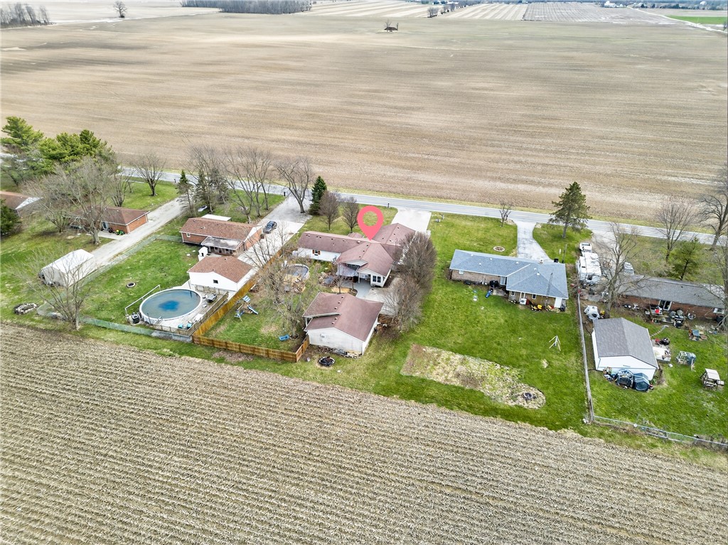 7888 Darke-Preble County Line Road Arcanum, OH 45304 - Photo 49 of 51 This property features expansive outdoor space with a pool and fencing, offering ample room for recreation.