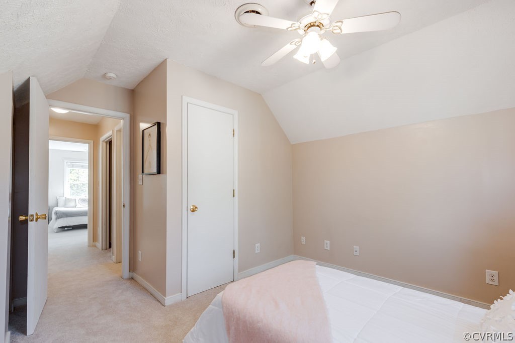 7005 Pointer Ridge Road Midlothian, VA 23112 - Photo 23 of 30 a bedroom with a white bed and a chandelier fan