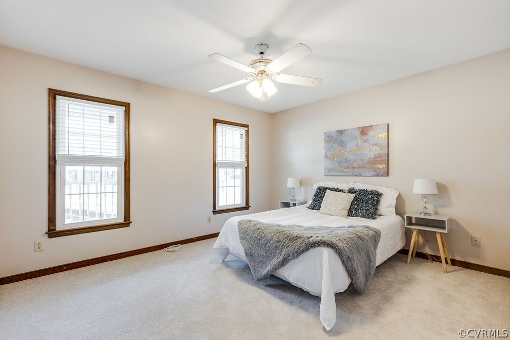 7005 Pointer Ridge Road Midlothian, VA 23112 - Photo 3 of 30 a bedroom with a large bed and a chandelier