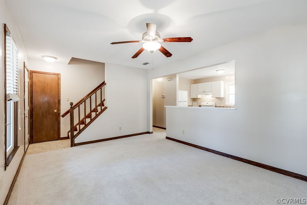 7005 Pointer Ridge Road Midlothian, VA 23112 - Photo 10 of 30 a view interior of a house with wooden stairs and a ceiling fan
