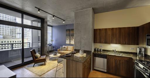 235 West Van Buren Street, Unit 3622 Chicago, IL 60607 - Photo 5 of 9 a kitchen with a table chairs stove and cabinets