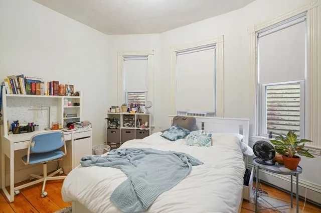 a bedroom with a bed and a chair